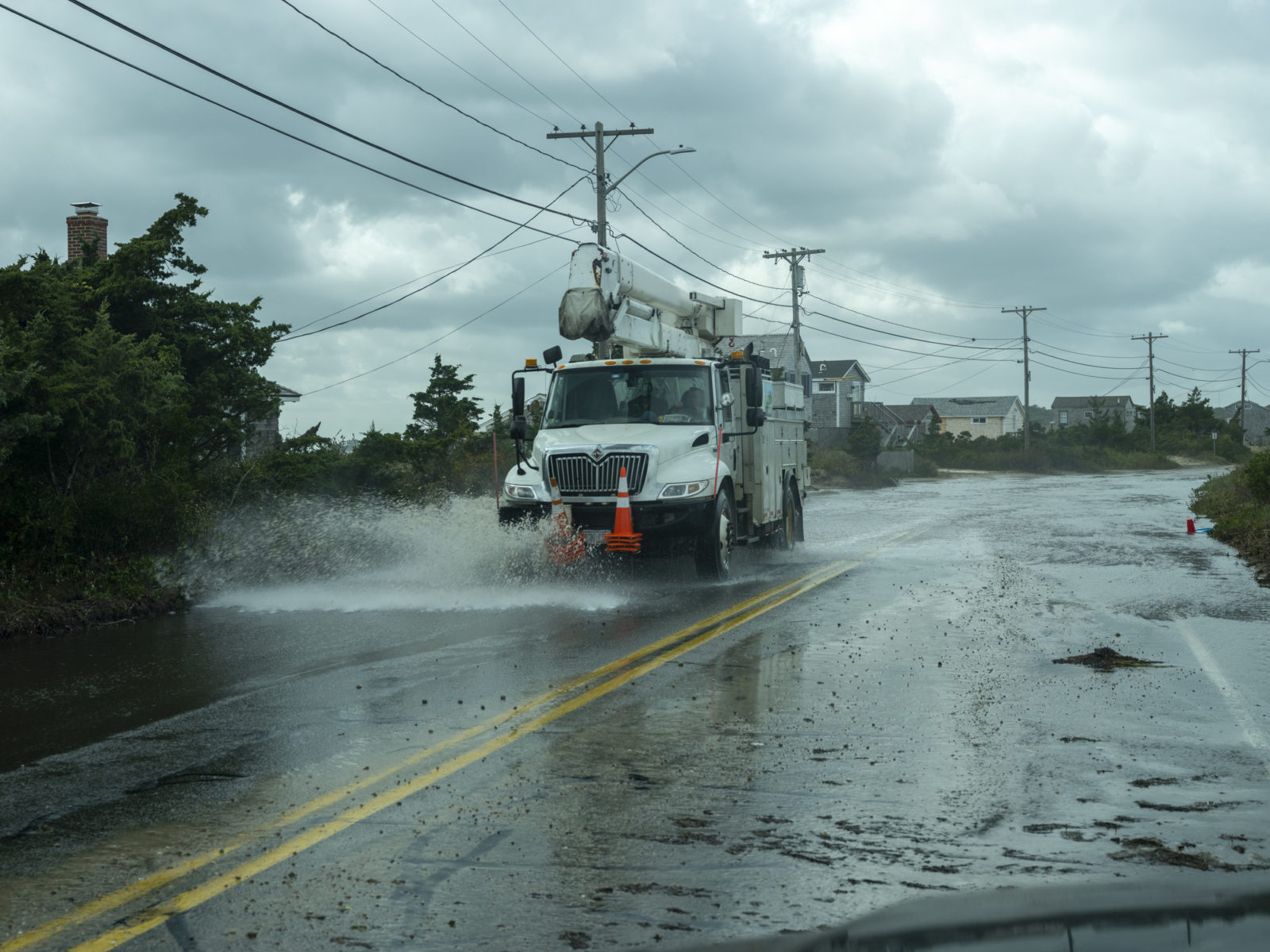 A picture of a utility truck driving in a storm, for a blog post on emergency preparation.