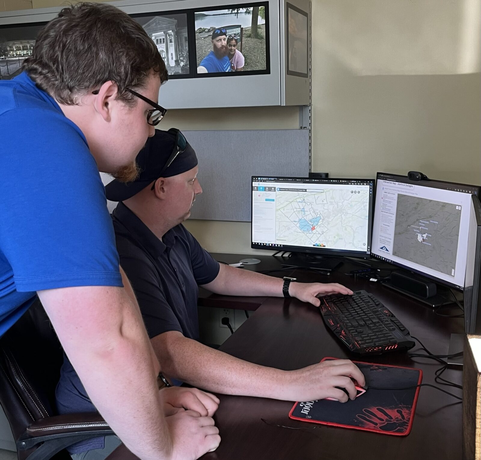 A picture of LCA employees Dan Stevens, asset management technology manager, and James Luma, GIS specialist, as they look at a computerized map of LCA assets, to illustrate a story on how LCA uses GIS to track assets.