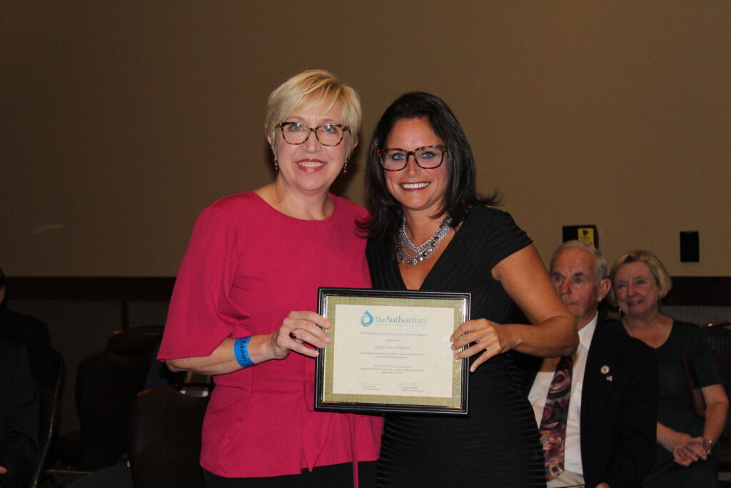 A picture of LCA communications manager Susan L. Sampson, at left, accepting the Municipal Authority Communications Award from Melissa Radovanic, PMAA Second Vice President.