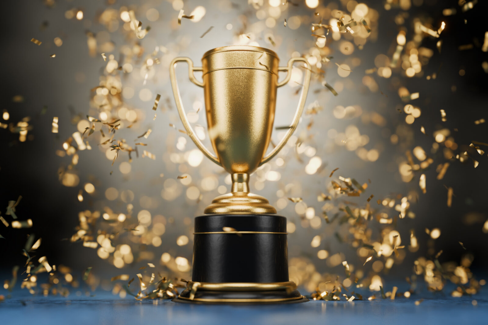 An image of a trophy cup against a black background as gold confetti falls, to symbolize LCA winning AWOP and accounting awards again in 2025.
