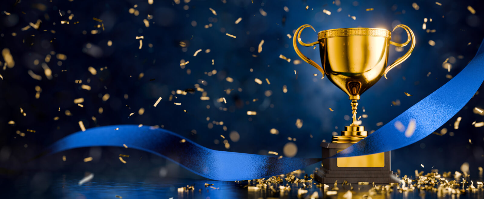 LCA has once again won awards for accounting and water treatment. An image of a gold trophy against a blue background, with a trailing blue ribbon.
